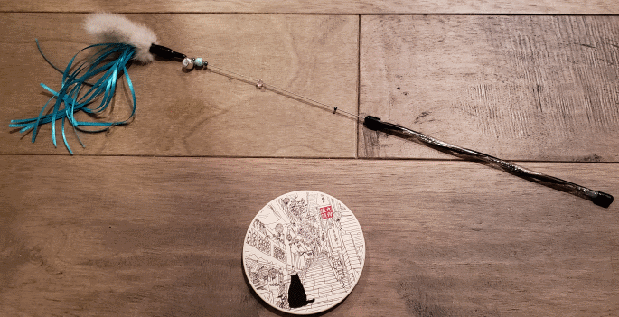 a wand toy and a coaster